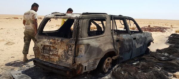 Men inspect the wreckage of a vehicle following clashes between forces loyal to eastern Libyan commander Khalifa Haftar and Benghazi Defence Brigades (BDB), an Islamist-leaning armed group, in the Magrun area, south of Benghazi, Libya July 21, 2016. Men inspect the wreckage of a vehicle following clashes between forces loyal to eastern Libyan commander Khalifa Haftar and Benghazi Defence Brigades (BDB), an Islamist-leaning armed group, in the Magrun area, south of Benghazi, Libya July 21, 2016. - Sputnik International