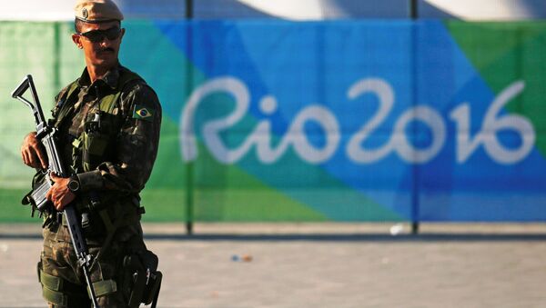 A special police forces officer stand guard outside the Olympic Park less than two weeks before the start of the Rio 2016 Olympic Games in the Barra da Tijuca neighborhood of Rio de Janeiro, Brazil, July 24, 2016. - Sputnik International