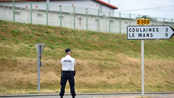 A police officer stands outside the prison of Le Mans Les Croisettes in Coulaines, on August 4, 2016, where two people including a prison warden and an inmate are held hostage by another inmate, according to police - Sputnik International