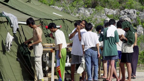 In this Sept. 21, 2001, file photo, men shave, brush their teeth and prepare for the day at a refugee camp on the Island of Nauru - Sputnik International