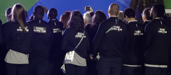 Members of the Refugee Olympic Team watch a welcome ceremony at the Olympic athletes village in Rio de Janeiro, Brazil, Wednesday, Aug. 3, 2016 - Sputnik International