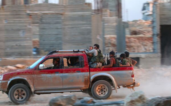 Fighters of the Syrian Islamist rebel group Jabhat Fateh al-Sham, the former al Qaeda-affiliated Nusra Front, ride on a pick-up truck in the 1070 Apartment Project area in southwestern Aleppo, Syria August 5, 2016 Fighters of the Syrian Islamist rebel group Jabhat Fateh al-Sham, the former al Qaeda-affiliated Nusra Front, ride on a pick-up truck in the 1070 Apartment Project area in southwestern Aleppo, Syria August 5, 2016 - Sputnik International