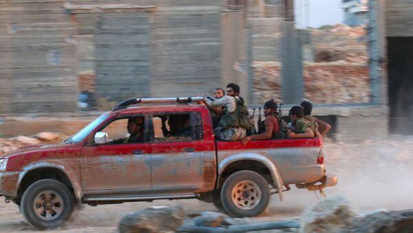 Fighters of the Syrian Islamist rebel group Jabhat Fateh al-Sham, the former al Qaeda-affiliated Nusra Front, ride on a pick-up truck in the 1070 Apartment Project area in southwestern Aleppo, Syria August 5, 2016 - Sputnik International