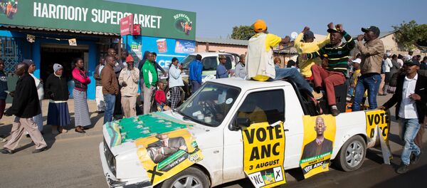 An ANC party vehicle appeals for votes as locals are seen outside a voting station during the Local Government elections in Diepsloot township, north of Johannesburg, South Africa An ANC party vehicle appeals for votes as locals are seen outside a voting station during the Local Government elections in Diepsloot township, north of Johannesburg, South Africa - Sputnik International