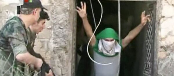 This still image from Syrian state TV video, shows a young man with his face covered surrendering to government forces, in Aleppo, Syria, Saturday, July 30, 2016 This still image from Syrian state TV video, shows a young man with his face covered surrendering to government forces, in Aleppo, Syria, Saturday, July 30, 2016 - Sputnik International