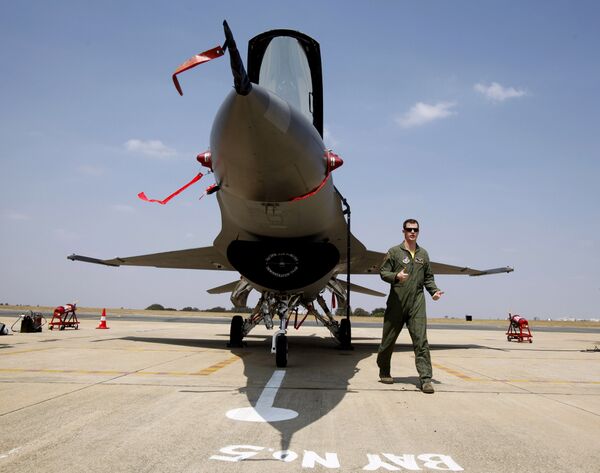 US Air Forces F-16 demonstration team pilot, Ryan Worrell from Iowa, walks past the F-16, a fighter aircraft, on display on the fourth day of the Aero India 2013 at Yelahanka air base in Bangalore, India, Saturday, Feb. 9, 2013 US Air Forces F-16 demonstration team pilot, Ryan Worrell from Iowa, walks past the F-16, a fighter aircraft, on display on the fourth day of the Aero India 2013 at Yelahanka air base in Bangalore, India, Saturday, Feb. 9, 2013 - Sputnik International