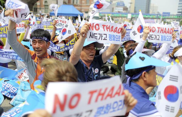 Residents in a rural South Korean town shout slogans in protest of a plan to deploy an advanced U.S. missile defense system called Terminal High-Altitude Area Defense, or THAAD, in their neighborhood, in Seoul, South Korea, Thursday, July 21, 2016 Residents in a rural South Korean town shout slogans in protest of a plan to deploy an advanced U.S. missile defense system called Terminal High-Altitude Area Defense, or THAAD, in their neighborhood, in Seoul, South Korea, Thursday, July 21, 2016 - Sputnik International