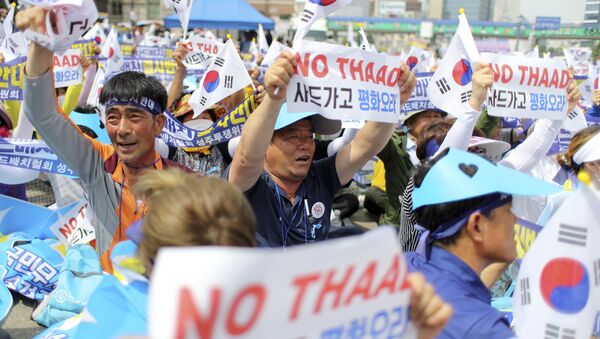 Residents in a rural South Korean town shout slogans in protest of a plan to deploy an advanced U.S. missile defense system called Terminal High-Altitude Area Defense, or THAAD, in their neighborhood, in Seoul, South Korea, Thursday, July 21, 2016 - Sputnik International