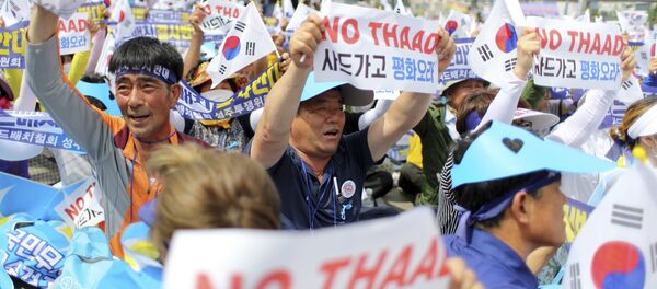 Residents in a rural South Korean town shout slogans in protest of a plan to deploy an advanced U.S. missile defense system called Terminal High-Altitude Area Defense, or THAAD, in their neighborhood, in Seoul, South Korea, Thursday, July 21, 2016 - Sputnik International