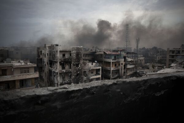 In this Tuesday, Oct. 2, 2012 file photo, smoke rises over Saif Al Dawla district, in Aleppo, Syria In this Tuesday, Oct. 2, 2012 file photo, smoke rises over Saif Al Dawla district, in Aleppo, Syria - Sputnik International