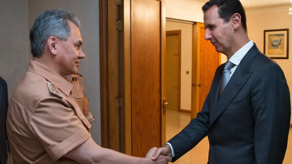 Russian Defense Minister Sergei Shoigu, left, and President of Syria Bashar al-Assad at a meeting in Syria - Sputnik International