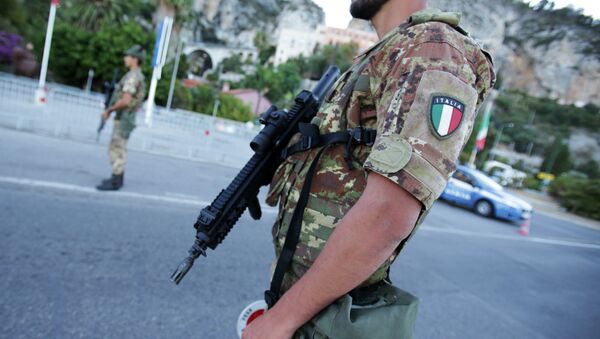 Italian servicemen stand guard and check vehicles at the Italian-French border in Ventimiglia, Italy (File) - Sputnik International