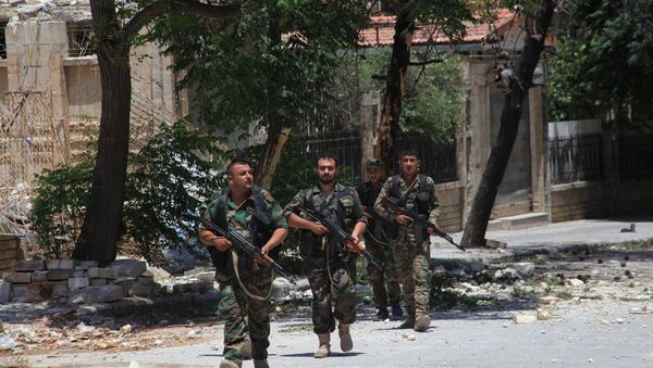 Syrian army soldiers patrol a street in government-controlled Aleppo's al-Khalidiya area (File) - Sputnik International