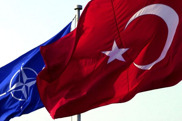 A Turkish flag waves in front of NATO's one A Turkish flag waves in front of NATO's one - Sputnik International