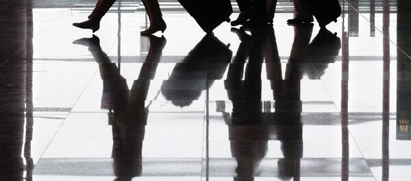 Travellers and their luggage are reflected on the floor at Terminal 3 of Beijing's Capital International Airport. (File) Travellers and their luggage are reflected on the floor at Terminal 3 of Beijing's Capital International Airport. (File) - Sputnik International