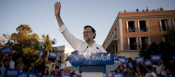 Leader of the People's Party (PP) and Spain's caretaker Prime Minister and party candidate, Mariano Rajoy, waves to supporters during a campaign meeting in Malaga. (File) - Sputnik International