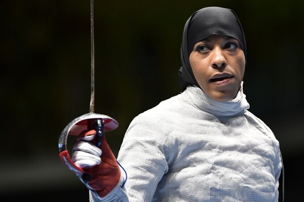 US Ibtihaj Muhammad reacts competing against France's Cecilia Berder in their women’s individual sabre qualifying bout as part of the fencing event of the Rio 2016 Olympic Games, on August 8, 2016, at the Carioca Arena 3, in Rio de Janeiro. US Ibtihaj Muhammad reacts competing against France's Cecilia Berder in their women’s individual sabre qualifying bout as part of the fencing event of the Rio 2016 Olympic Games, on August 8, 2016, at the Carioca Arena 3, in Rio de Janeiro. - Sputnik International