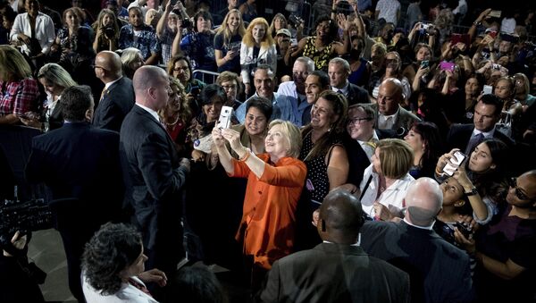 Democratic presidential candidate Hillary Clinton takes a photo with a member of the audience after speaking at a rally at Osceola Heritage Park, in Kissimmee, Fla., Monday, Aug. 8, 2016. - Sputnik International