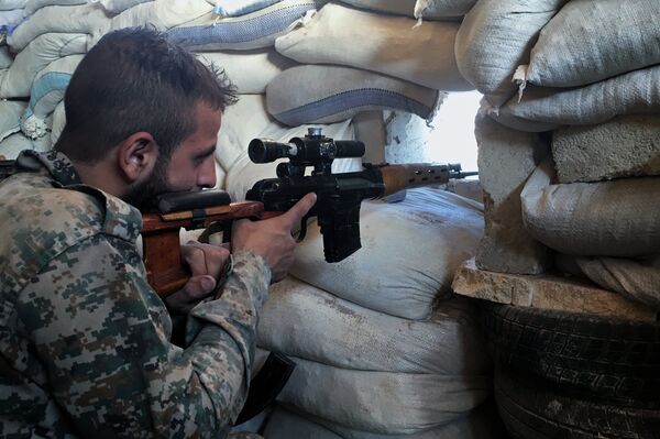 A Syrian Army soldier at the front line against a military logistics school in southern Aleppo A Syrian Army soldier at the front line against a military logistics school in southern Aleppo - Sputnik International