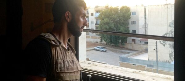 A Syrian Army soldier examines a position from an apartment window in southern Aleppo A Syrian Army soldier examines a position from an apartment window in southern Aleppo - Sputnik International