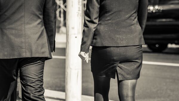 Man and woman dressed in suits - Sputnik International