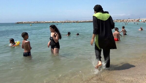 Nissrine Samali, 20, gets into the sea wearing traditional Islamic dress, in Marseille, southern France (File) - Sputnik International
