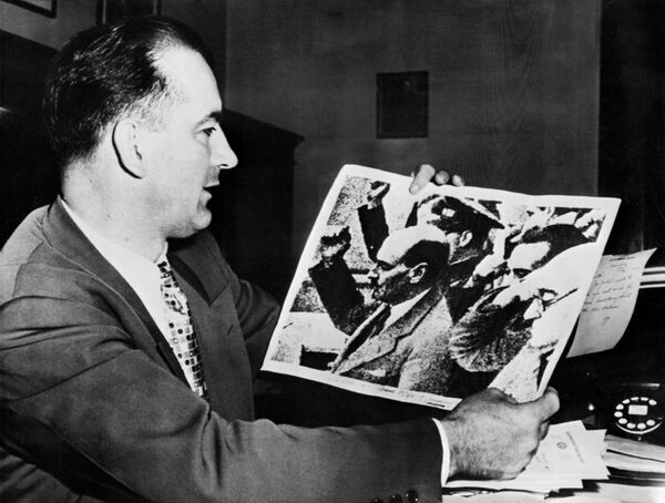 US Senator Joseph McCarthy holds a picture showing Clement Richard Attlee, British statesman and Prime minister (1945-1951) making a communist salute during the Spanish civil war. John Parnell Thomas and MacCarthy instigated an anti-commnist witchhunt campaign in the early 1950's, a period known as McCarthyism US Senator Joseph McCarthy holds a picture showing Clement Richard Attlee, British statesman and Prime minister (1945-1951) making a communist salute during the Spanish civil war. John Parnell Thomas and MacCarthy instigated an anti-commnist witchhunt campaign in the early 1950's, a period known as McCarthyism - Sputnik International