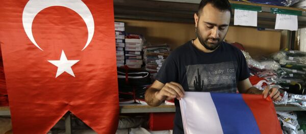 An employee of a flag-making factory folds a Russian flag as a Turkish flag adorns the display at left, in Istanbul, Tuesday, Aug. 9, 2016 An employee of a flag-making factory folds a Russian flag as a Turkish flag adorns the display at left, in Istanbul, Tuesday, Aug. 9, 2016 - Sputnik International