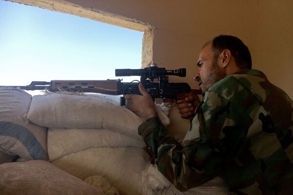 A Syrian army soldier during the assault on the artillery school in the south-east of Aleppo, Syria A Syrian army soldier during the assault on the artillery school in the south-east of Aleppo, Syria - Sputnik International