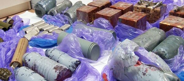 In this grab taken from a footage provided by Russian Federal Security Service Press Service, explosive devices and ammunition confiscated from a group that Russia's Federal Security Service (FSB) identified as Ukrainian 'saboteurs,' are placed on the floor by experts in Crimea on Thursday, Aug. 11, 2016 - Sputnik International