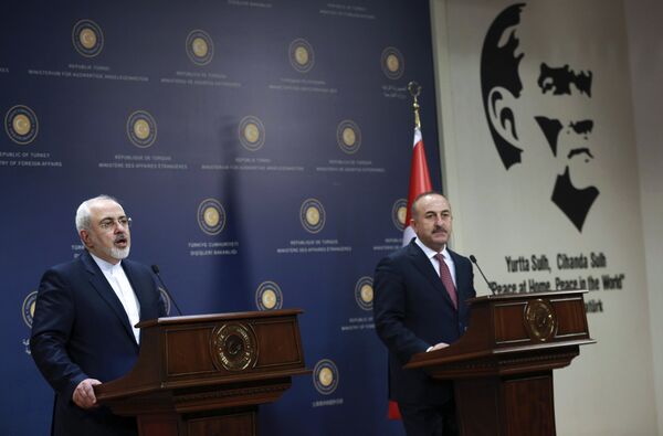 Turkish Foreign Minister Mevlut Cavusoglu (R) and his Iranian counterpart Mohammad Javad Zarif address a joint press conference following their meeting, next to a picture of Mustafa Kemal Ataturk, founder of the Turkish Republic, at the Foreign Ministry in Ankara on August 12, 2016 - Sputnik International