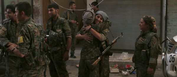 Syria Democratic Forces (SDF) female fighters embrace each other in the city of Manbij, in Aleppo Governorate, Syria, August 10, 2016 Syria Democratic Forces (SDF) female fighters embrace each other in the city of Manbij, in Aleppo Governorate, Syria, August 10, 2016 - Sputnik International