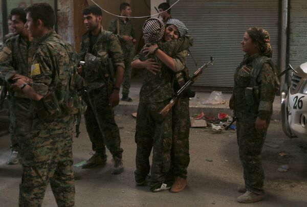 Syria Democratic Forces (SDF) female fighters embrace each other in the city of Manbij, in Aleppo Governorate, Syria, August 10, 2016 Syria Democratic Forces (SDF) female fighters embrace each other in the city of Manbij, in Aleppo Governorate, Syria, August 10, 2016 - Sputnik International