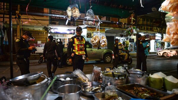 Police inspect a near-empty parking lot where the popular and busy night market should have been held in the upscale resort town of Hua Hin on August 12, 2016 - Sputnik International