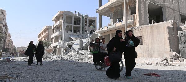 Women react as they walk along a street after they were evacuated with others by the Syria Democratic Forces (SDF) fighters from an Islamic State-controlled neighbourhood of Manbij, in Aleppo Governorate, Syria, August 12, 2016 - Sputnik International