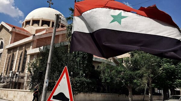 A state flag of the Syrian Arab Republic by an Orthodox church in an old Christian block of Aleppo, Syria - Sputnik International