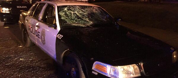 A police car with broken windows is seen in a photograph released by the Milwaukee Police Department after disturbances following the police shooting of a man in Milwaukee, Wisconsin, U.S. August 13, 2016 A police car with broken windows is seen in a photograph released by the Milwaukee Police Department after disturbances following the police shooting of a man in Milwaukee, Wisconsin, U.S. August 13, 2016 - Sputnik International