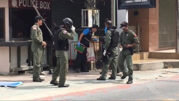 Officials investigate at the scene of bomb blasts in the tourist beach town of Patong on Phuket island, Thailand in this still image from video August 12, 2016 - Sputnik International