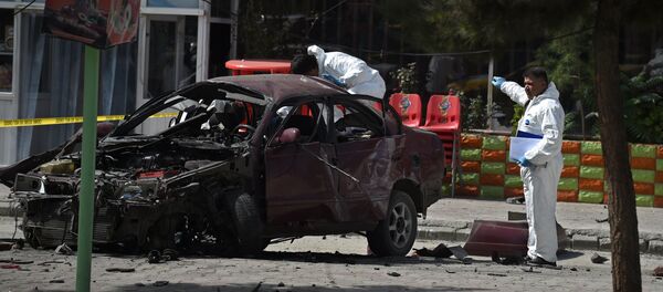 Afghan security personnel inspect a damaged car at the site of a suicide bomb attack near the US embassy in Kabul on August 15, 2016 Afghan security personnel inspect a damaged car at the site of a suicide bomb attack near the US embassy in Kabul on August 15, 2016 - Sputnik International
