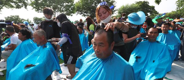 More than 900 Seongju residents have their heads shaved during a protest against the planned deployment of the US Terminal High Altitude Area Defense (THAAD) system at a local park in the southeastern town of Seongju on August 15, 2016 More than 900 Seongju residents have their heads shaved during a protest against the planned deployment of the US Terminal High Altitude Area Defense (THAAD) system at a local park in the southeastern town of Seongju on August 15, 2016 - Sputnik International