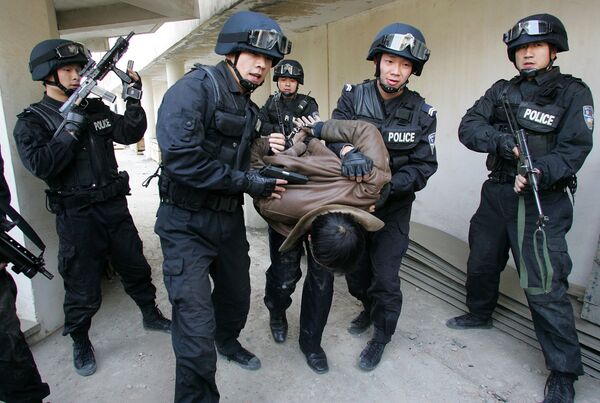 Members of the Special Weapons and Tactics Team (SWAT) of the Xian police force arrest a 'terrorist' during a drill at the Qujiang Waterworks in Xian, northwestern China's Shaanxi province. file photo Members of the Special Weapons and Tactics Team (SWAT) of the Xian police force arrest a 'terrorist' during a drill at the Qujiang Waterworks in Xian, northwestern China's Shaanxi province. file photo - Sputnik International