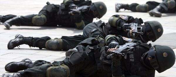 Special police forces demonstrate their craft during a drill to mark the launch of a training program on Beijing Olympic Games security held at the Beijing People's Police Institute on the outskirts of Beijing, China. file photo - Sputnik International