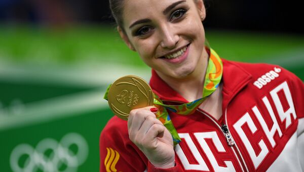 Aliya Mustafina (Russia), winner of the gold medal in the uneven bars event of the women’s artistic gymnastics competition at the XXXI Summer Olympics, during the medal ceremony - Sputnik International