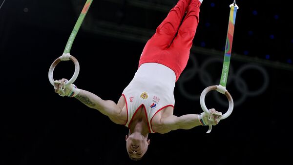 Denis Ablyazin (Russia) performs his still rings routine during the qualifying round of the men’s artistic gymnastics competition at the XXXI Summer Olympics - Sputnik International