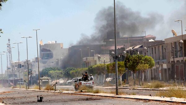 Fighters ride a pickup truck as smoke rises during a battle with Islamic State fighters in neighborhood Number Two in Sirte, Libya - Sputnik International