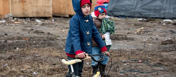 Migrant children play in the southern part of the so-called 'Jungle' migrant camp in Calais, northern France Migrant children play in the southern part of the so-called 'Jungle' migrant camp in Calais, northern France - Sputnik International