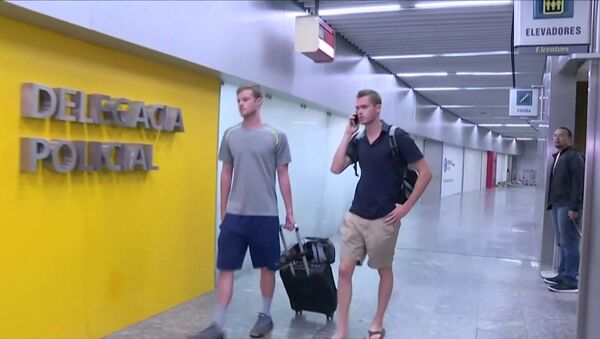 U.S. Olympic swimmers Gunnar Bentz and Jack Conger walk to the airport police station office at Rio's international airport in this still frame taken from video dated August 17, 2016, in Rio De Janeiro, Brazil. - Sputnik International