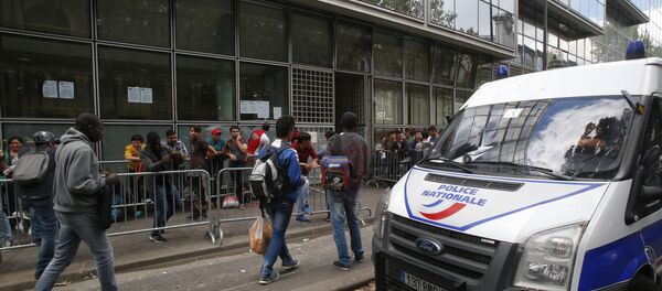 A police van parks as refugees queue outside a refugees center in Paris A police van parks as refugees queue outside a refugees center in Paris - Sputnik International