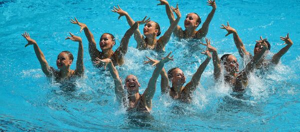 The Russian team performs the technical routine at the synchronized swimming group event at the XXXI Summer Olympics - Sputnik International