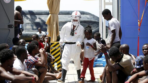 Migrants are rescued during a MOAS operation off the coast of Libya August 18, 2016 in this handout picture courtesy of the Italian Red Cross released on August 19, 2016. Picture taken August 18, 2016 - Sputnik International